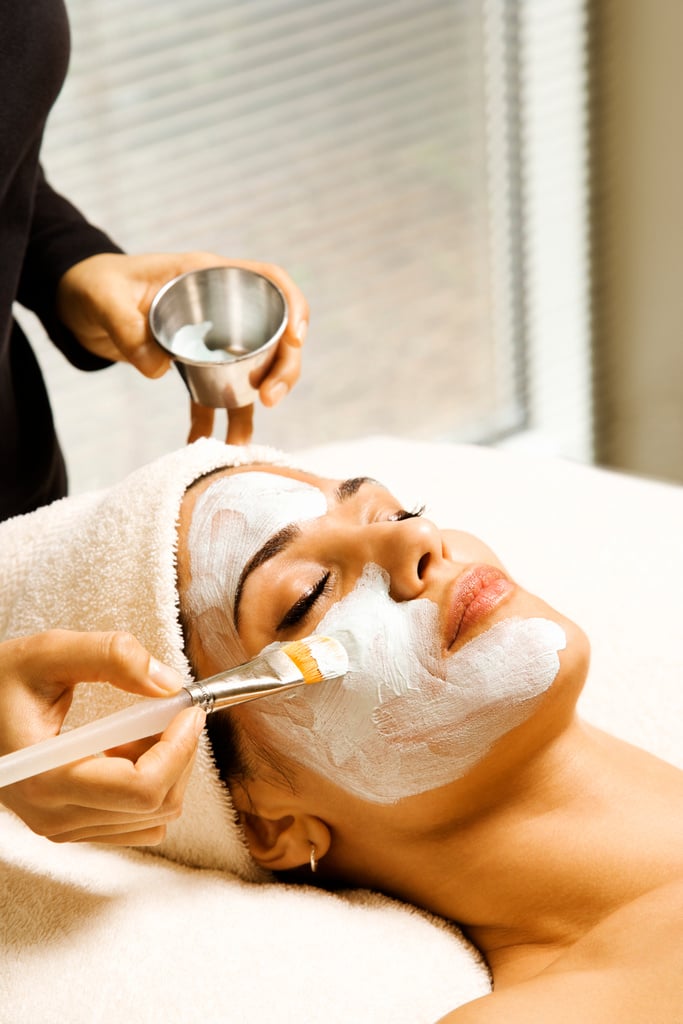 Woman receiving facial treatment at spa